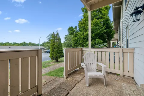 a wooden bench sitting in front of a building
