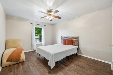 a bedroom with a bed and wooden floor
