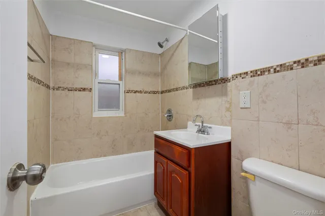 a bathroom with a sink toilet vanity and shower