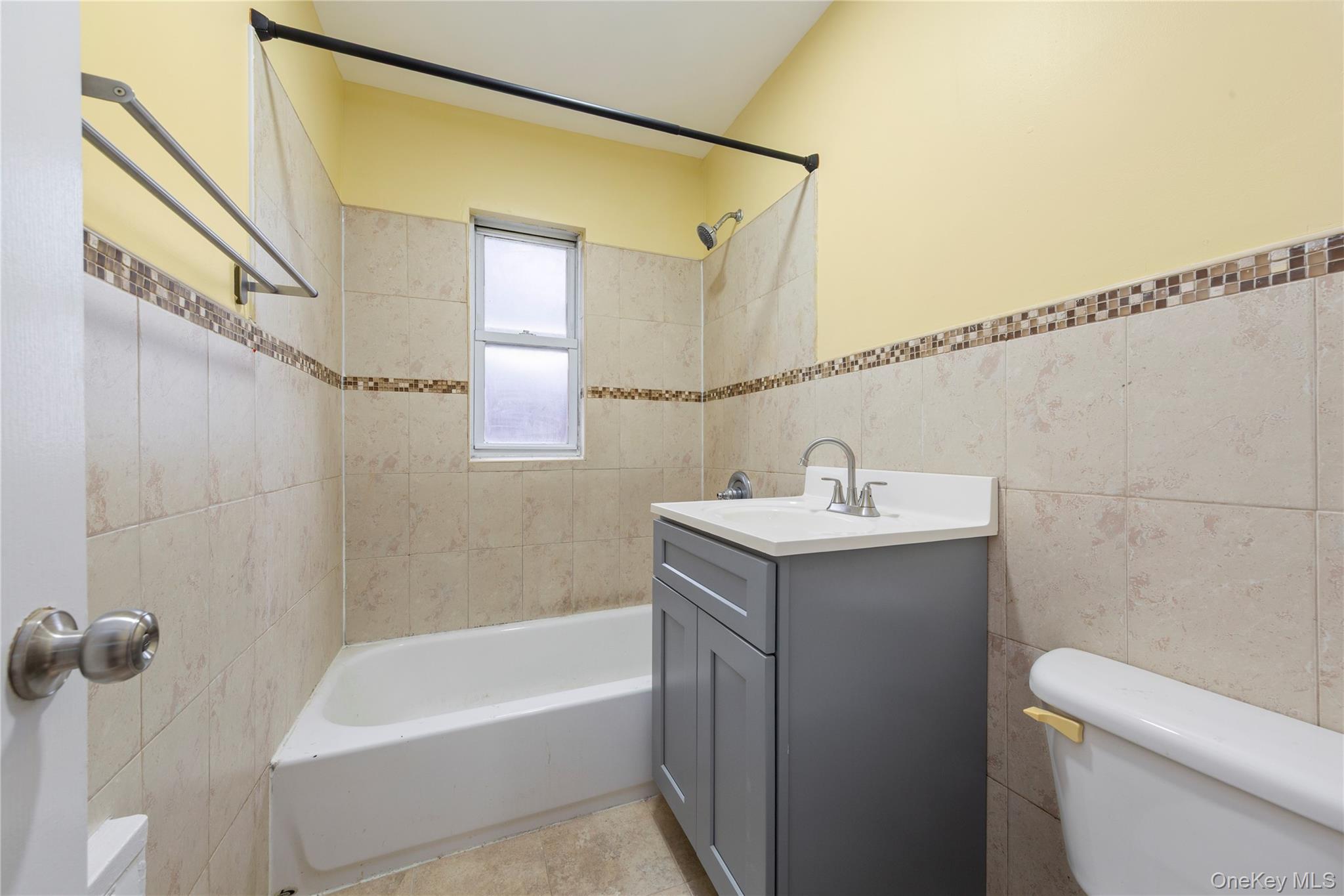 91-41 195th Street Queens, NY 11423 - Photo 15 of 31 a bathroom with a sink a toilet and shower