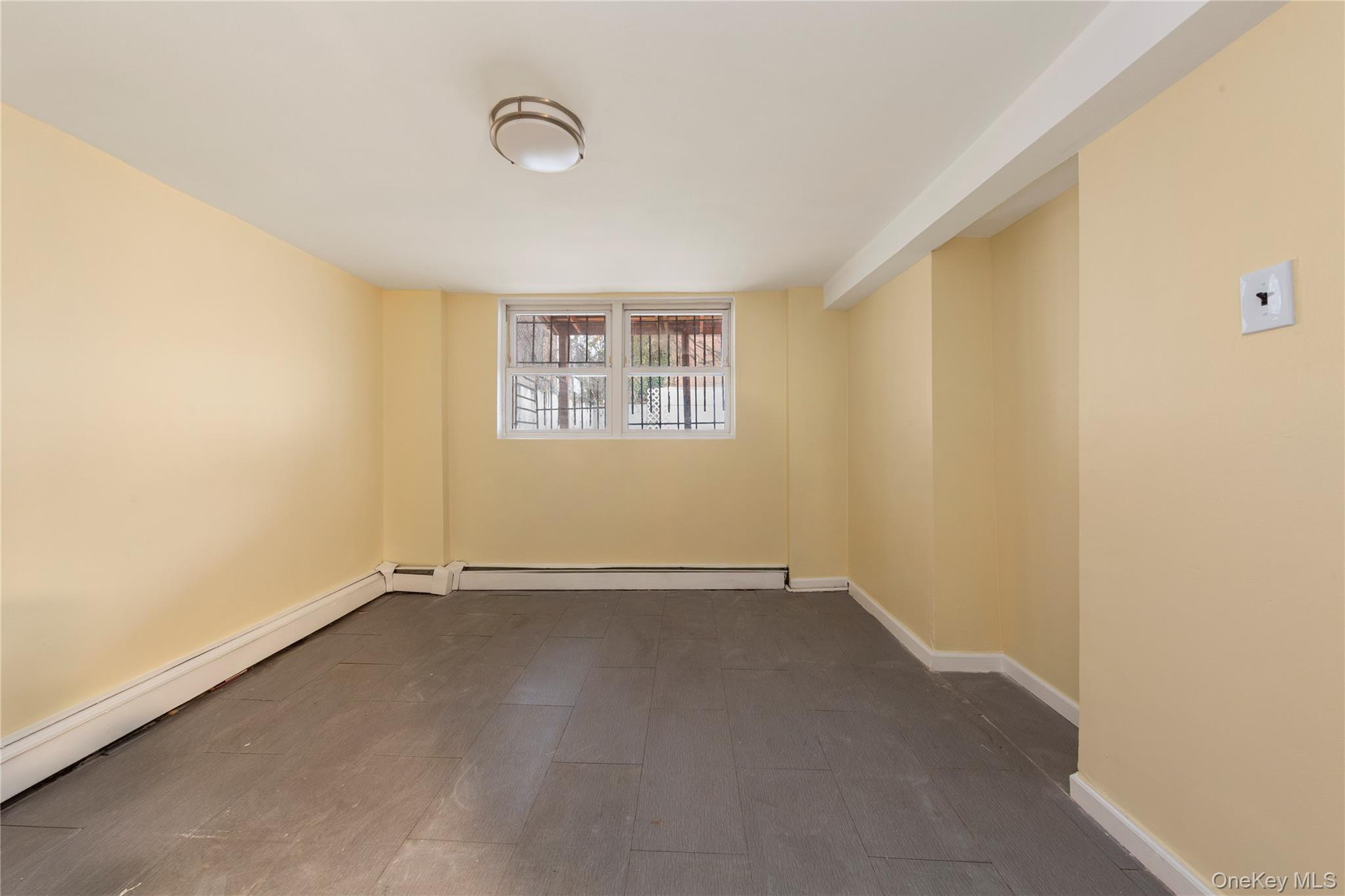 91-41 195th Street Queens, NY 11423 - Photo 20 of 31 a view of an empty room with a window