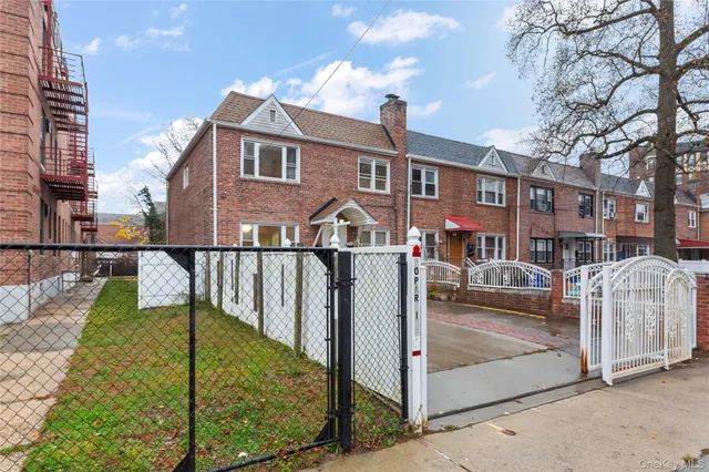 a view of a house with wooden floor next to a yard