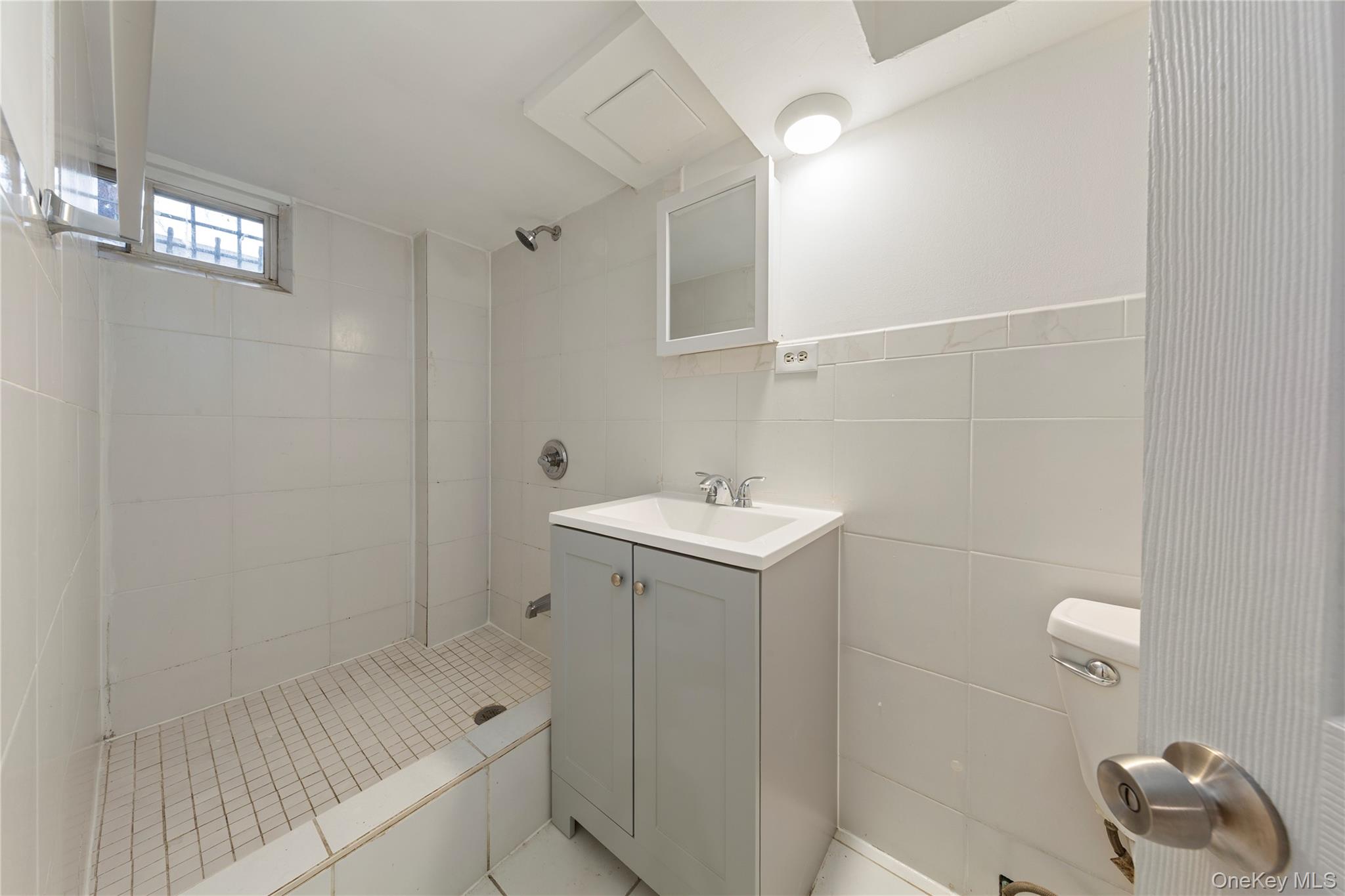 91-41 195th Street Queens, NY 11423 - Photo 21 of 31 a bathroom with a sink toilet and shower