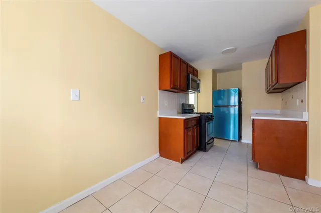 a kitchen with stainless steel appliances a refrigerator and a stove