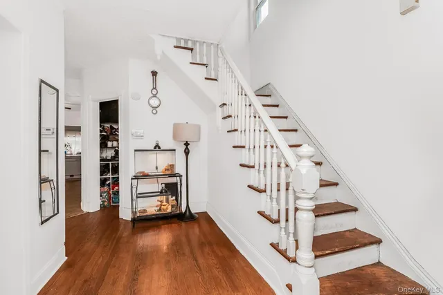 a view of entryway and hall with wooden floor