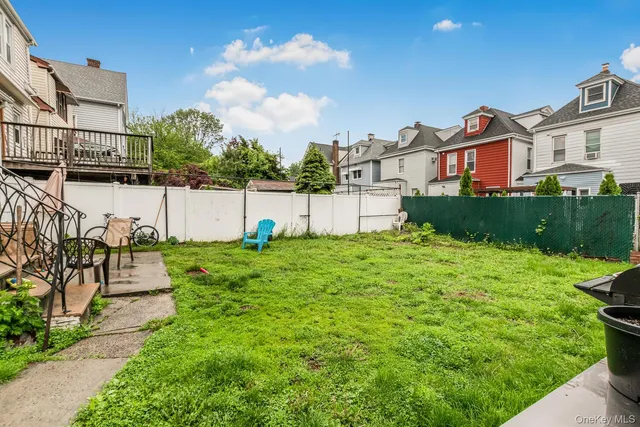 a view of a house with a yard and a fountain