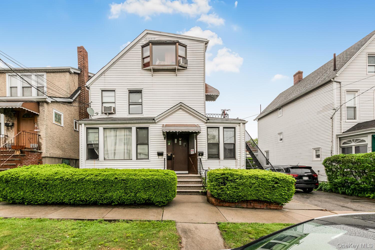 32 Alexander Avenue Yonkers, NY 10704 - Photo 2 of 16 a front view of a house with a yard