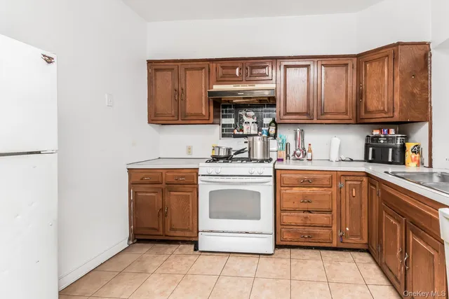 a kitchen with stainless steel appliances a stove sink and cabinets