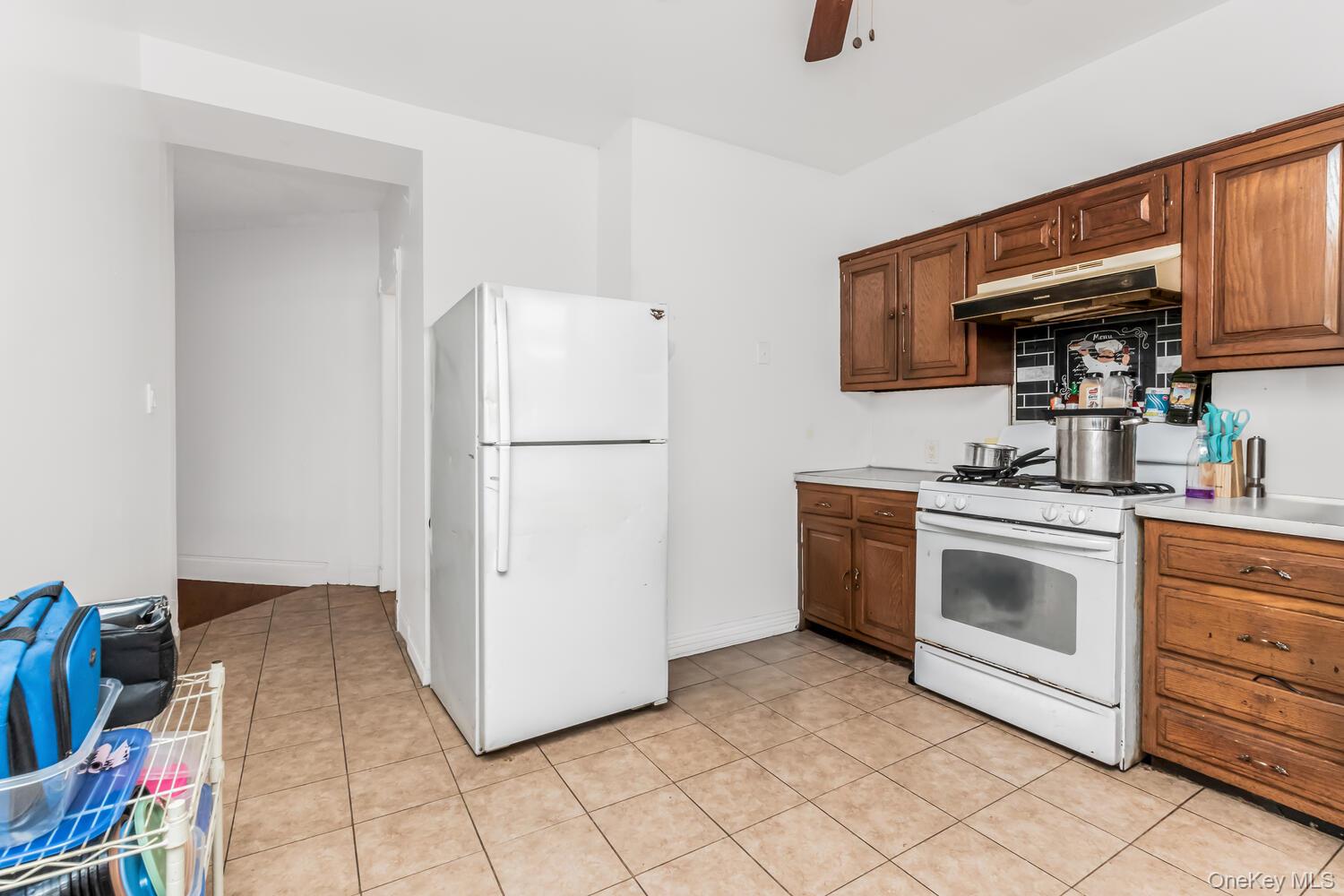 32 Alexander Avenue Yonkers, NY 10704 - Photo 7 of 16 a kitchen with a refrigerator sink and cabinets