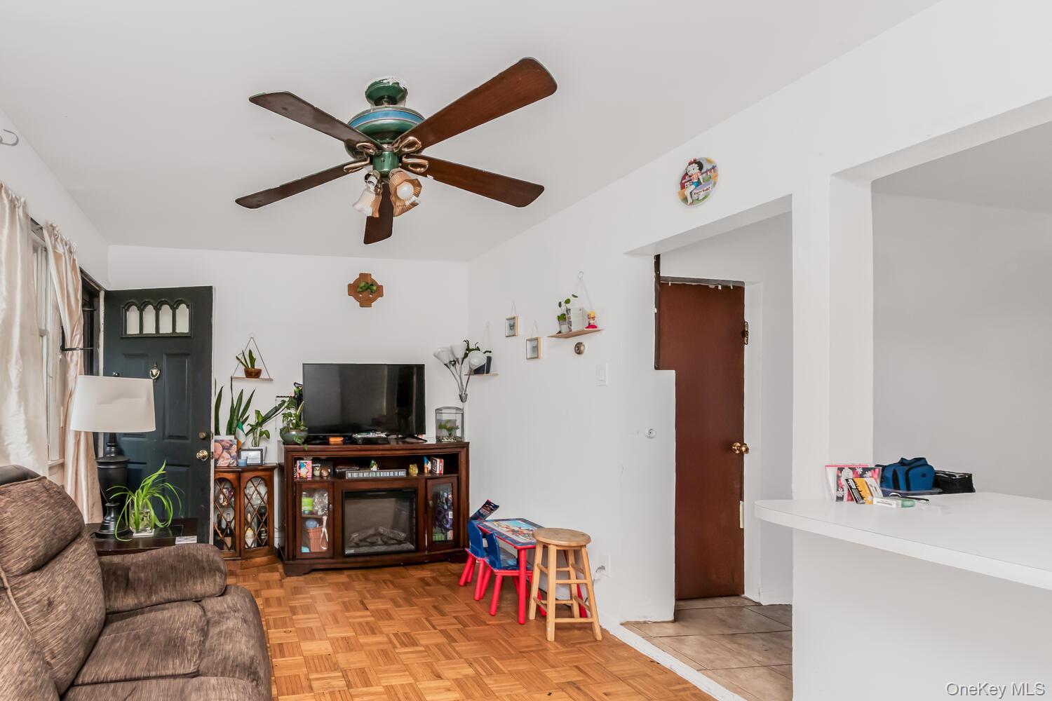 32 Alexander Avenue Yonkers, NY 10704 - Photo 9 of 16 a living room with furniture and a flat screen tv