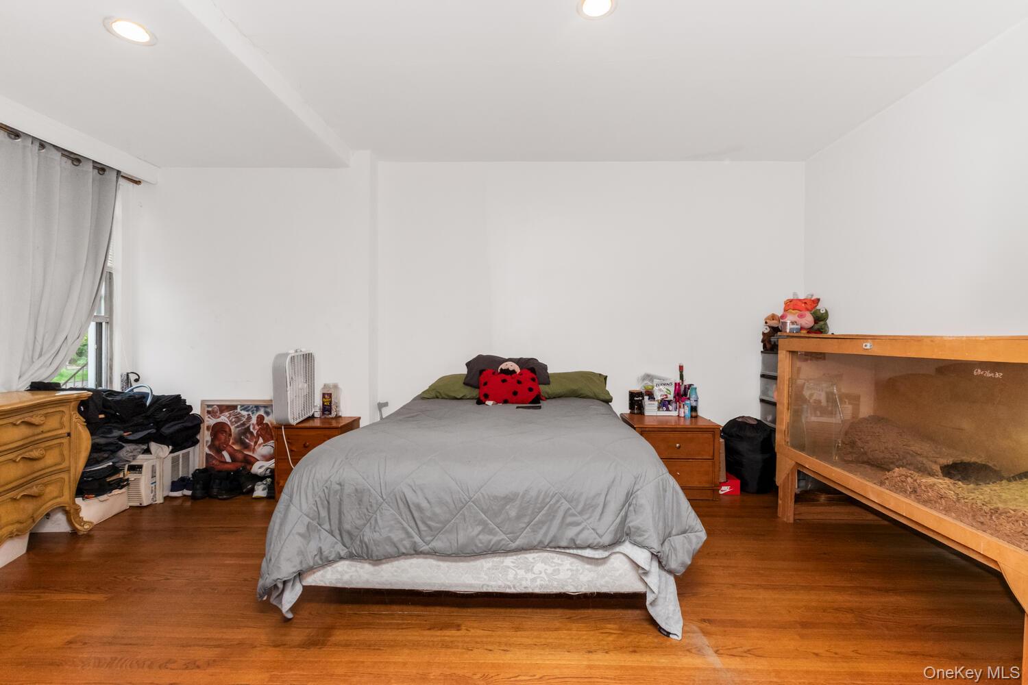 32 Alexander Avenue Yonkers, NY 10704 - Photo 10 of 16 a bedroom with a bed and a couch