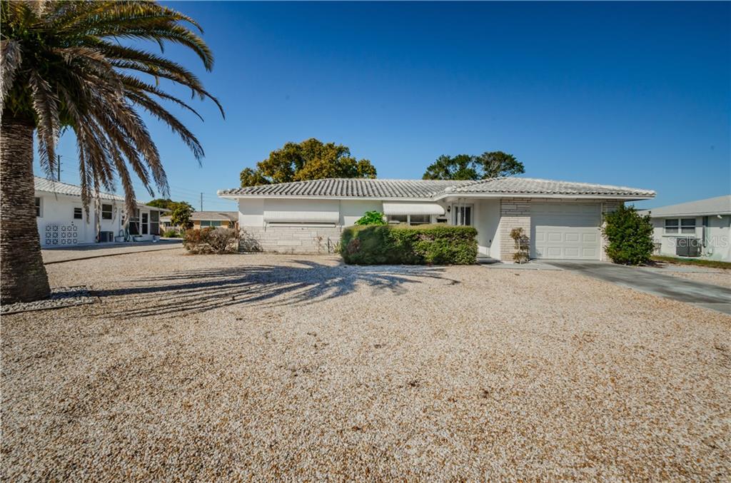 10441 Sweet Lane Port Richey, FL 34668 - Photo 1 of 1 a front view of a house with a yard