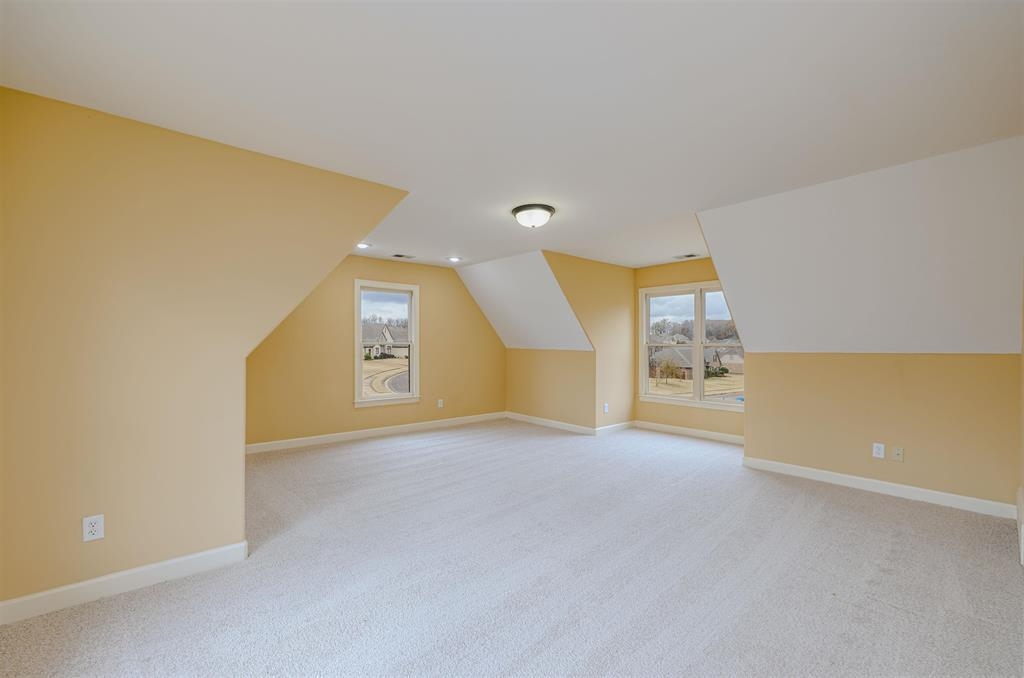 5380 Scarlet Ridge Drive Arlington, TN 38002 - Photo 23 of 35 Spacious attic room with light-colored carpeting, multiple windows, recessed lighting, and a flush-mount ceiling fixture