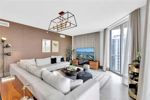 a living room with furniture and a large window