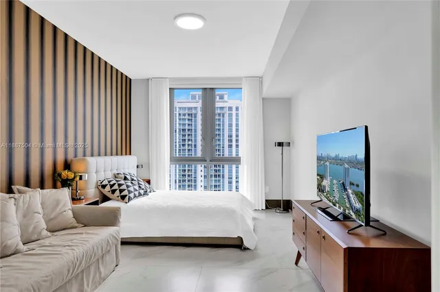 a view of a hallway with a chair and flower pot