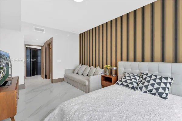 a bathroom with a glass door shower and a sink