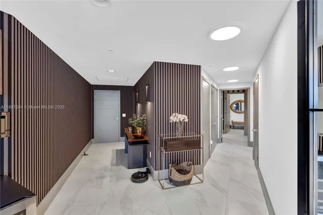a large white kitchen with sink and refrigerator