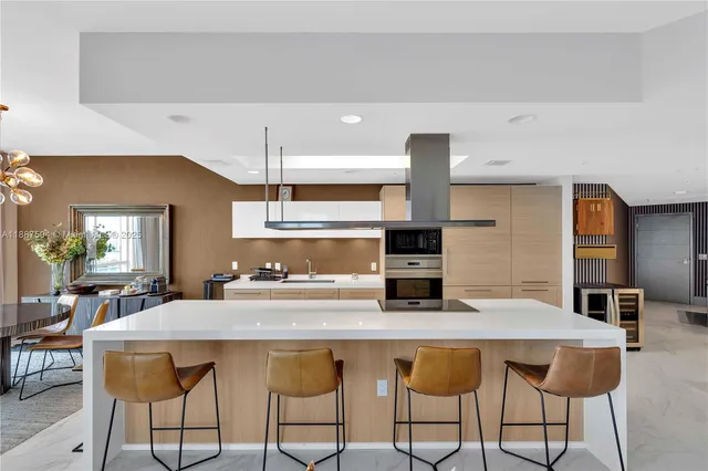 a dining room with furniture a chandelier and wooden floor