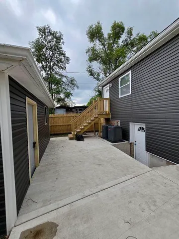 a view of the house with a yard