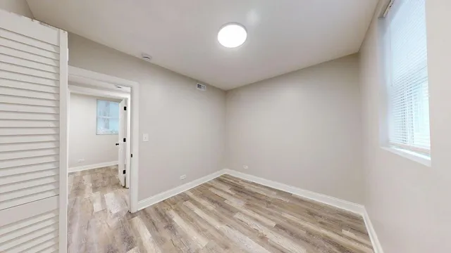 a view of a room with wooden floor and windows