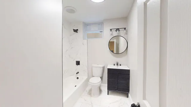 a bathroom with a sink a toilet and a shower