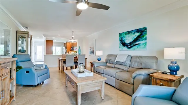 a living room with furniture and a floor to ceiling window