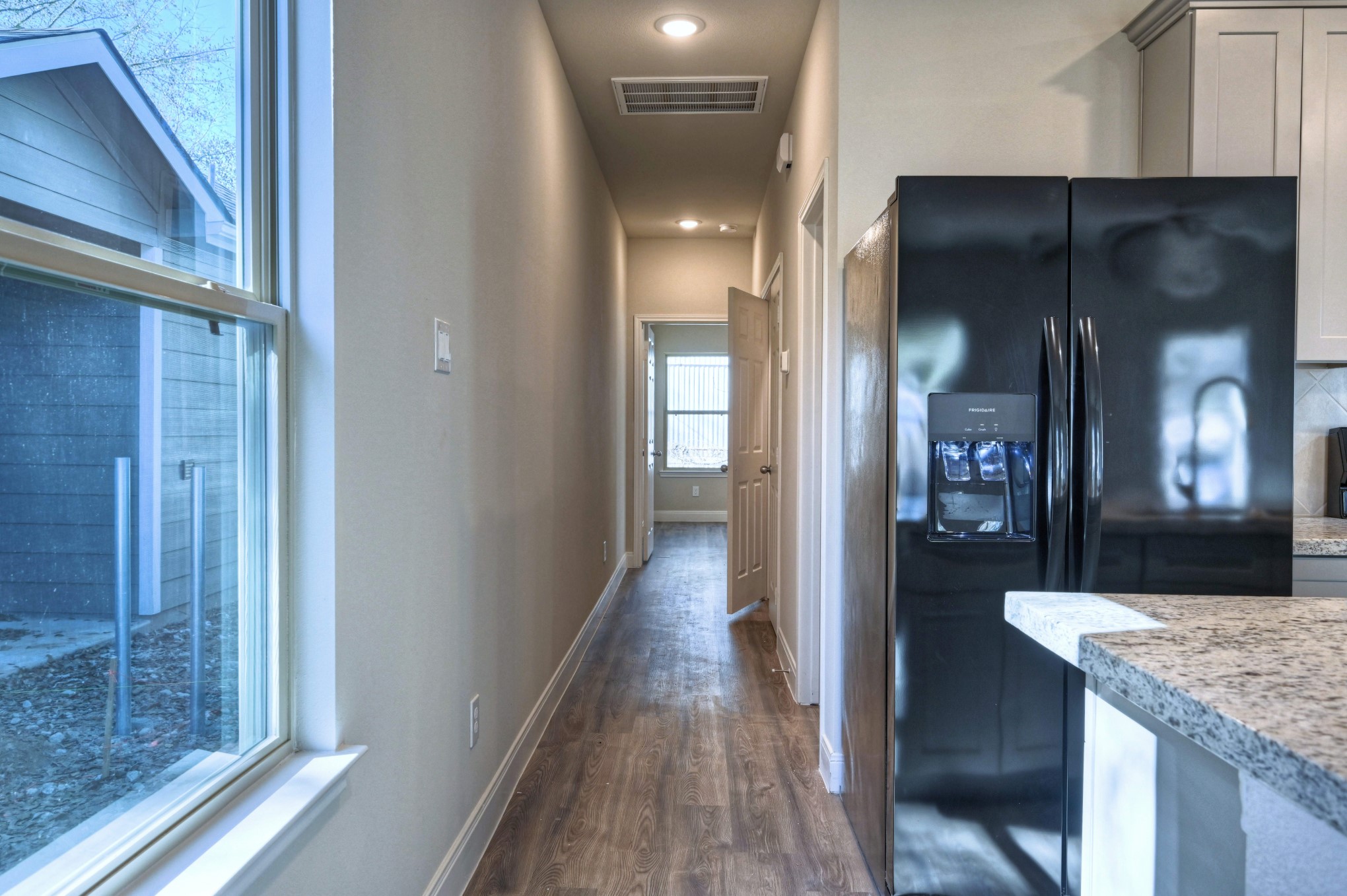 9173 Inwood Willis, TX 77318 - Photo 10 of 31 a view of a hallway to a livingroom and a kitchen with furniture