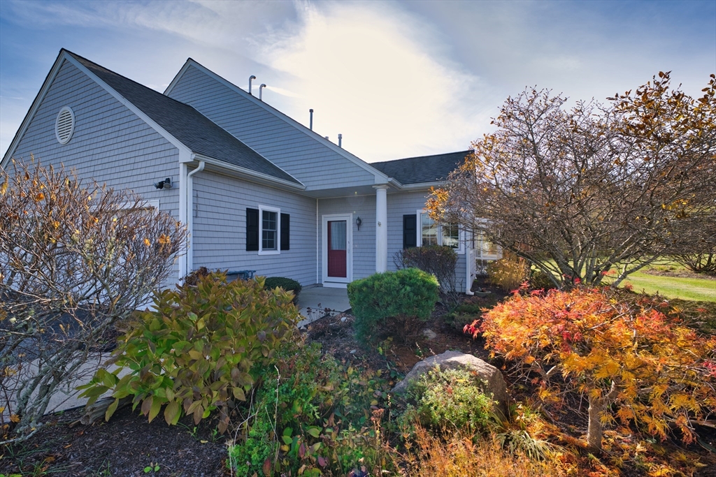 8 Village Way, Unit 8 Westport, MA 02790 - Photo 1 of 29 a front view of a house with a yard