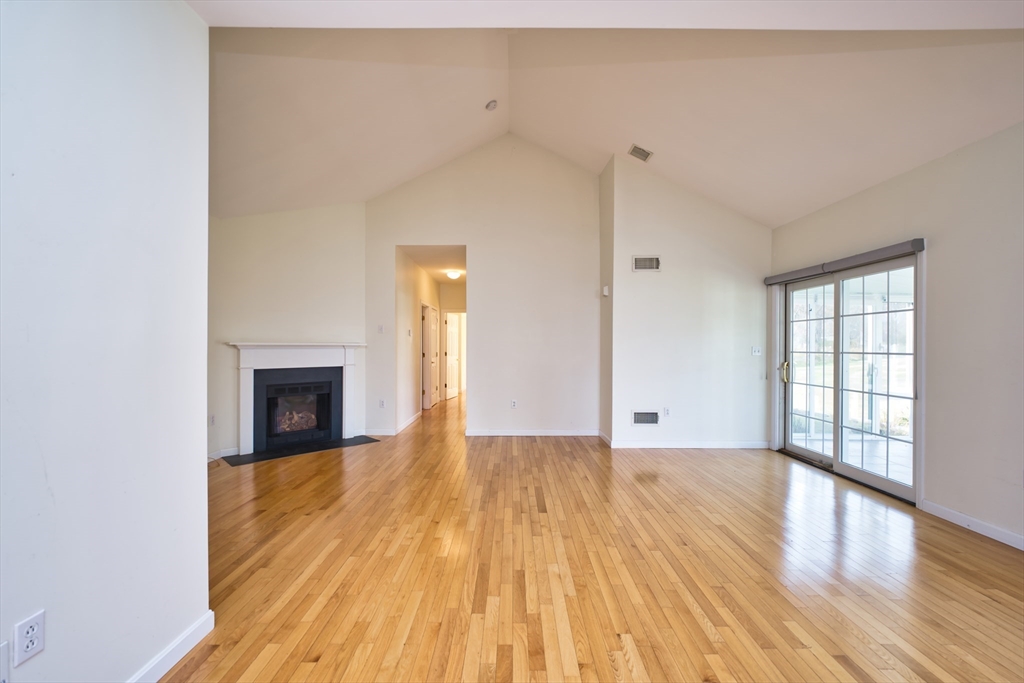 8 Village Way, Unit 8 Westport, MA 02790 - Photo 15 of 29 a view of an empty room with wooden floor and a window