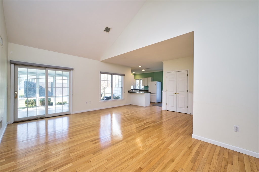 8 Village Way, Unit 8 Westport, MA 02790 - Photo 16 of 29 a view of an empty room with wooden floor and a window