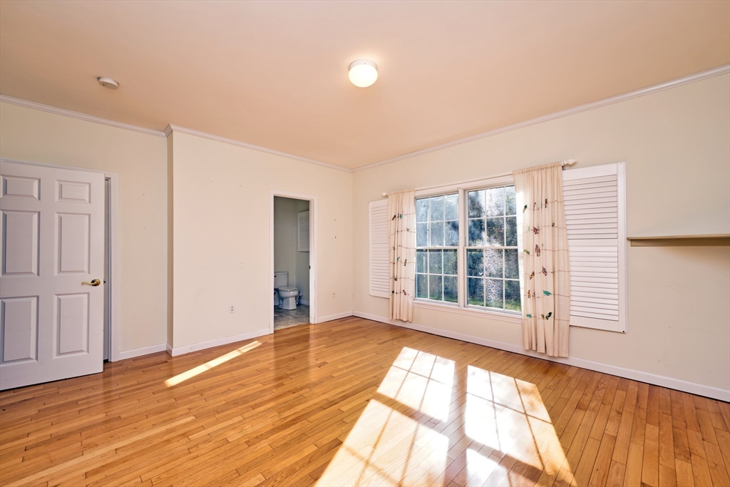 8 Village Way, Unit 8 Westport, MA 02790 - Photo 20 of 29 a view of an empty room with wooden floor and a window