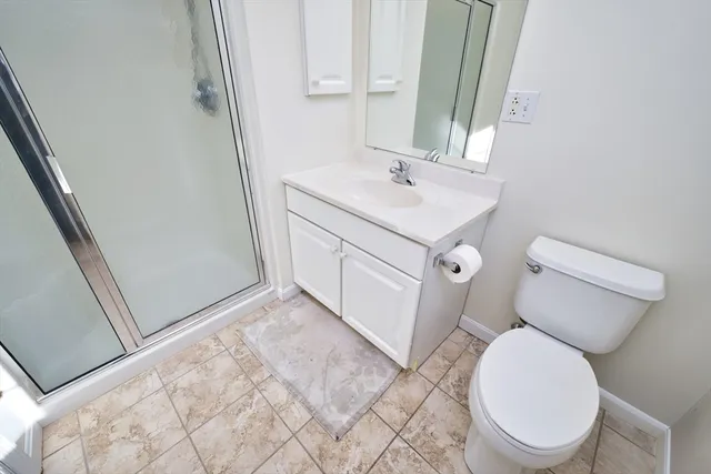 a white toilet sitting next to a bathroom sink