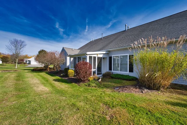 a view of a house with backyard porch and sitting area