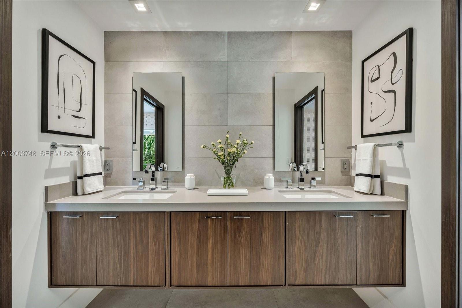 2675 Hackney Road Weston, FL 33331 - Photo 53 of 61 a bathroom with double vanity sinks and a mirror