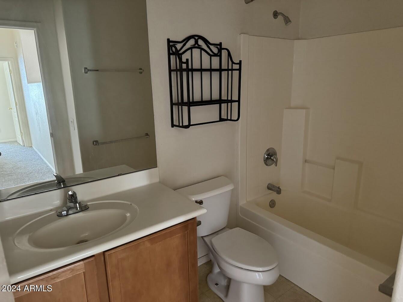 9401 West Berkeley Road Phoenix, AZ 85037 - Photo 22 of 27 a bathroom with a granite countertop toilet sink and mirror