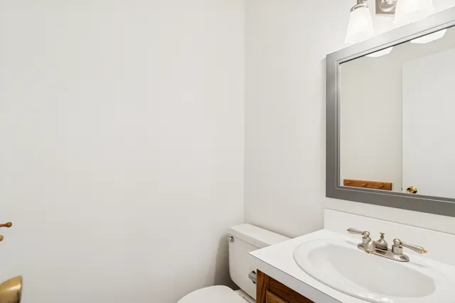 a bathroom with a sink a mirror and a toilet