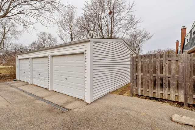 a view of a house with a wooden fence