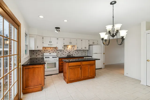 a kitchen with stainless steel appliances granite countertop a sink and cabinets