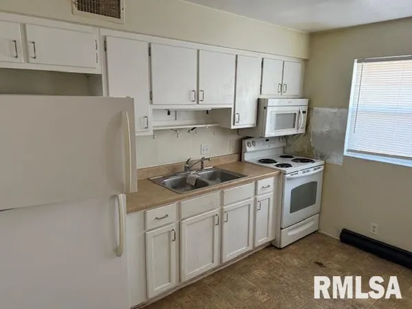 a kitchen with stainless steel appliances granite countertop a sink a stove and a refrigerator