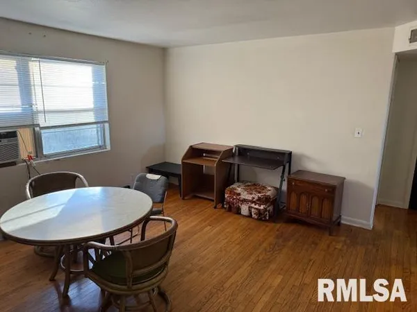 a bedroom with furniture and wooden floor