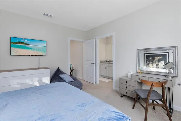 a bedroom with a bed and a desk