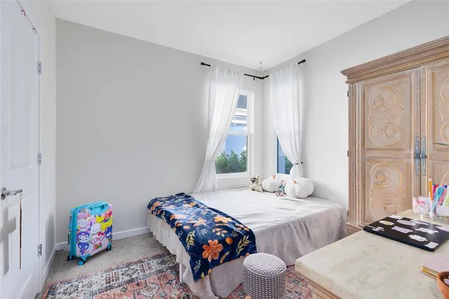 a bedroom with bed and a window