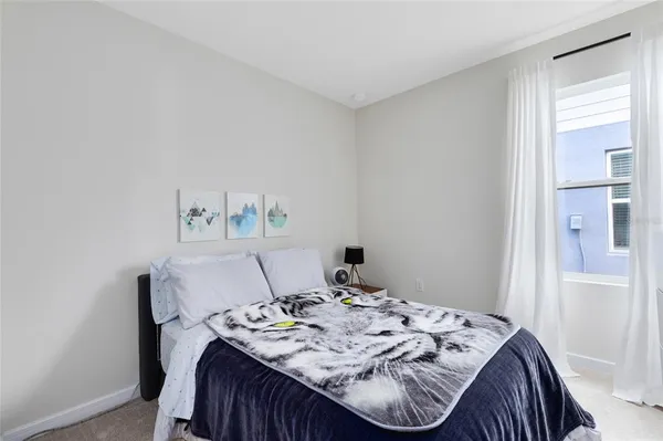 a bed sitting in a bedroom next to a window