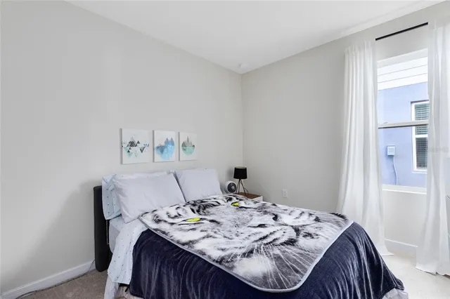 a bed sitting in a bedroom next to a window