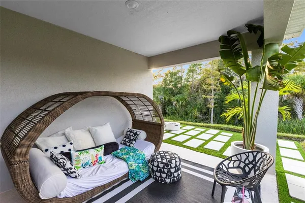a living room with furniture and a potted plant