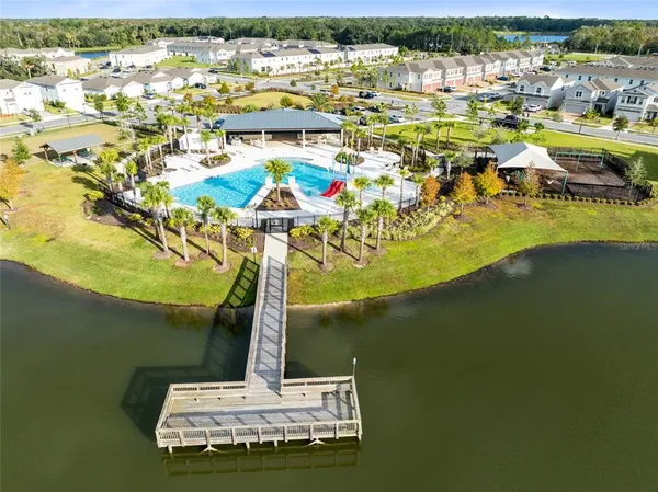 a ocean view with beach and residential houses with outdoor space