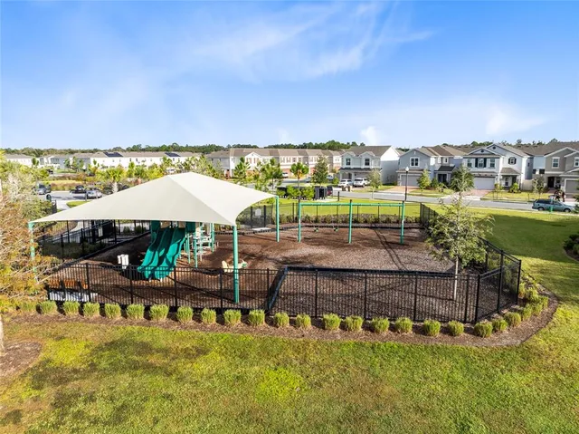 a view of a swimming pool with lawn chairs under an umbrella