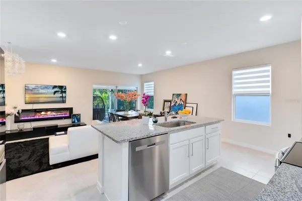 a kitchen with counter top space appliances and windows