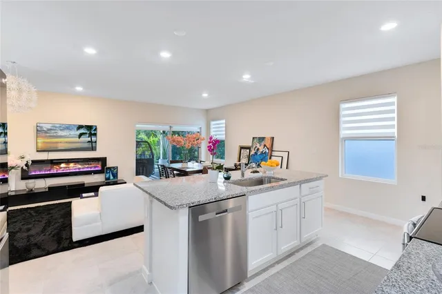 a kitchen with counter top space appliances and windows