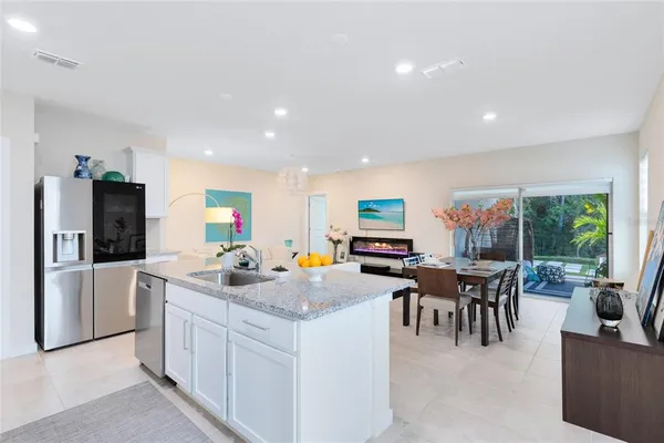a kitchen with a stove a refrigerator and a dining table